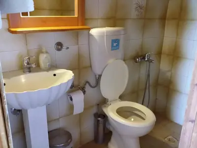 a bathroom with a toilet and a sink at 2bedrooms Cottage 1 in Palaiochóra