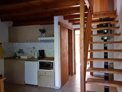 a kitchen with a stove and a staircase in a house at 2bedrooms Cottage 1 in Palaiochóra
