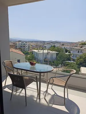 a table and chairs on a balcony with a view at Alchania komi luxury apartment in Chania Town