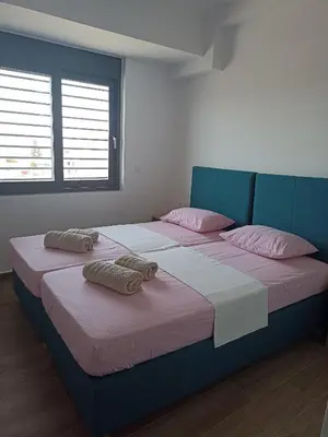 a bedroom with a large bed with pink pillows at Alchania komi luxury apartment in Chania Town