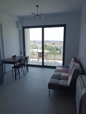 a living room with a couch and a table at Alchania komi luxury apartment in Chania Town