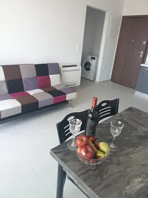 a table with a bowl of fruit and a bottle of wine at Alchania komi luxury apartment in Chania Town