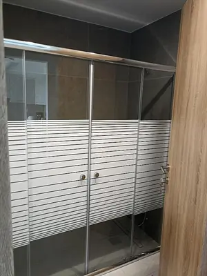 a shower stall with glass doors in a bathroom at Alchania komi luxury apartment in Chania Town