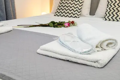 a pile of towels and towels on a bed at Koum Kapi Studio B1 in Chania Town