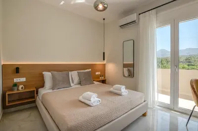 a bedroom with a bed with towels on it at Villenia Luxury Apartments in Kissamos