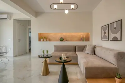 a living room with a couch and a table at Villenia Luxury Apartments in Kissamos