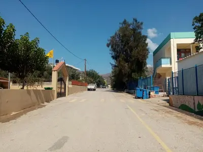 an empty street in a small town with a building at Vine Veranda in Palaiochóra