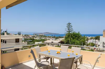a patio with a table and chairs on a balcony at AnnaBoutique Villa Next to Beach Private Pool & BBQ in Kato Daratso