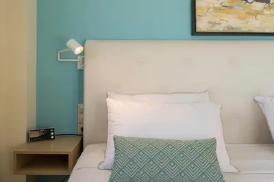 a bed with a white headboard and a pillow at AnnaBoutique Villa Next to Beach Private Pool & BBQ in Kato Daratso