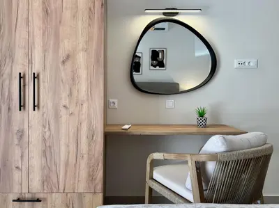 a dressing table with a mirror and a chair at Villa Karissa in Gavalochori