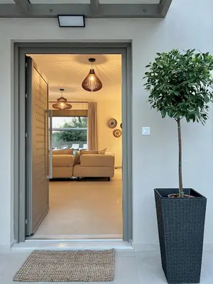 a door leading to a living room with a couch at Villa Karissa in Gavalochori