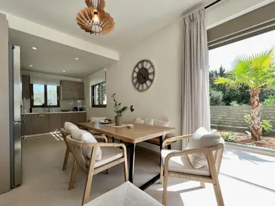 a kitchen and dining room with a table and chairs at Villa Karissa in Gavalochori