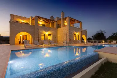 a large swimming pool in front of a house at Villas Kalives in Kalyves