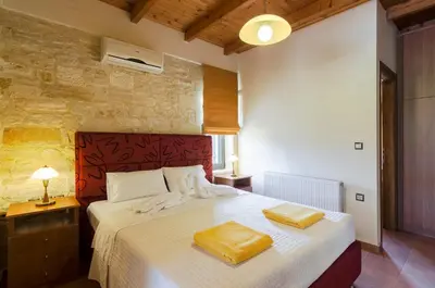 a bedroom with a bed with two towels on it at Villas Kalives in Kalyves