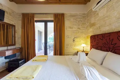 a bedroom with a large bed with a large window at Villas Kalives in Kalyves