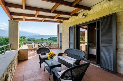 a patio with chairs and a table on a balcony at Villas Kalives in Kalyves