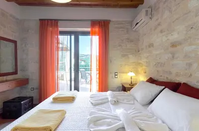 a bedroom with a large bed and a window at Villas Kalives in Kalyves