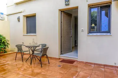 a patio with a table and chairs next to a building at Dictamus apartment in Chania Town
