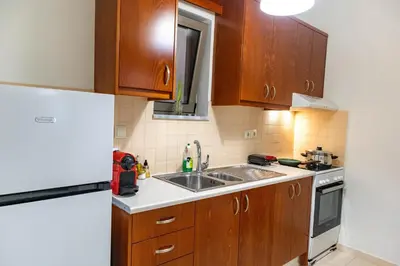 a kitchen with a sink and a refrigerator at Dictamus apartment in Chania Town