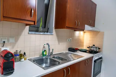 a kitchen with a sink and a stove at Dictamus apartment in Chania Town