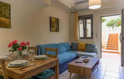 a living room with a blue couch and a table at Dictamus apartment in Chania Town