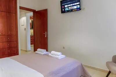 a bedroom with a bed with towels on it at Dictamus apartment in Chania Town