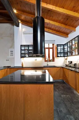 a kitchen with a black sink and wooden cabinets at Luminous a House of Luxury in Chania Town