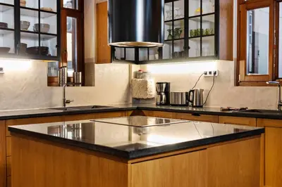 a kitchen with a large island in the middle at Luminous a House of Luxury in Chania Town