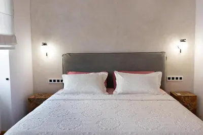 a bedroom with a white bed with two pillows at Luminous a House of Luxury in Chania Town