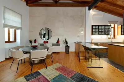 a kitchen and dining room with a table and chairs at Luminous a House of Luxury in Chania Town