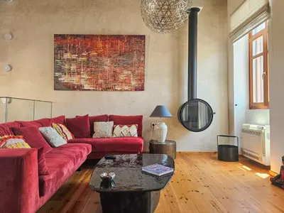 a living room with a red couch and a table at Luminous a House of Luxury in Chania Town