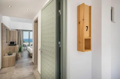 a hallway with a door leading to a living room at Glykeria Hotel in Elafonisi