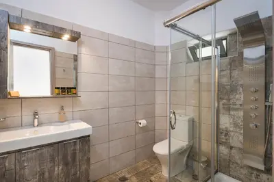 a bathroom with a toilet and a sink and a shower at Glykeria Hotel in Elafonisi