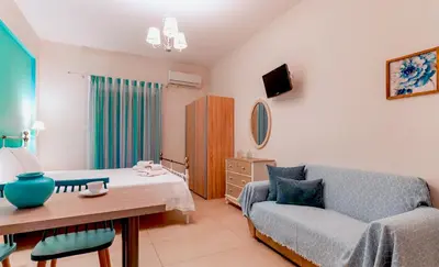 a living room with a couch and a table at Kaiti 's Studios & Apartments in Palaiochóra