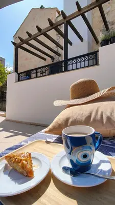 a cup of coffee and a slice of pie on a table at Villa Penelope Luxury Retreat with Pool & Timeless Charm in Douliana