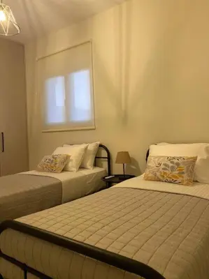 a bedroom with two beds and a window at Thalassa Grammeno seaview house in Palaiochóra