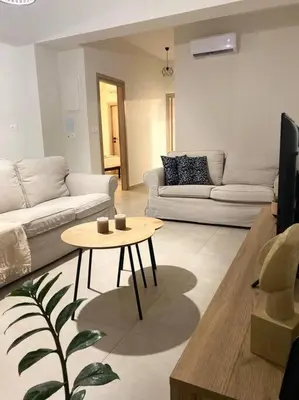 a living room with a couch and a table at Thalassa Grammeno seaview house in Palaiochóra