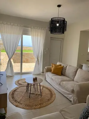 a living room with a couch and a table at Thalassa Grammeno seaview house in Palaiochóra