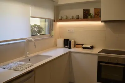 a kitchen with a sink and a counter top at Downtown Delight in Chania Town