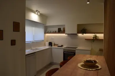 a kitchen with a wooden table with a bowl on it at Downtown Delight in Chania Town