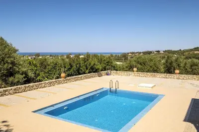 a swimming pool in the middle of a patio at Kayzo Luxury Apartment With Pool in Tavronitis