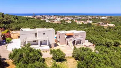 an aerial view of a house on a hill at Kayzo Luxury Apartment With Pool in Tavronitis
