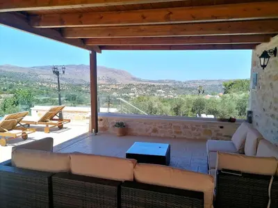 a living room with a couch and a table at VILLA HALEPOURI in Chania Town