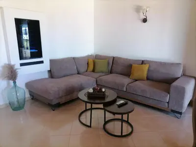 a living room with a couch and a table at VILLA HALEPOURI in Chania Town