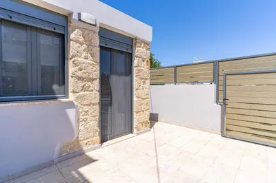 a house with a gate and a garage at Myra city House in Chania Town