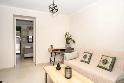 a living room with a couch and a table at Myra city House in Chania Town