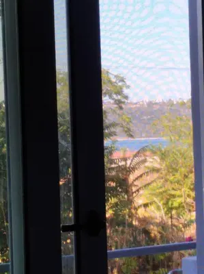 an open window with a view of a tree at Souda Bay in Souda