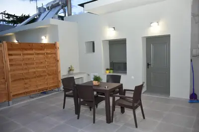 a dining room with a wooden table and chairs at Manolis cozy home in Chania Town