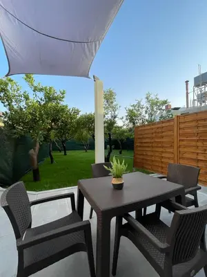 a patio with a table and chairs and a fence at Manolis cozy home in Chania Town