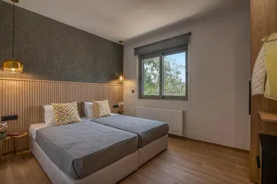 a bedroom with a bed and a window at Alyona Villas - Villa Lona in Skinés